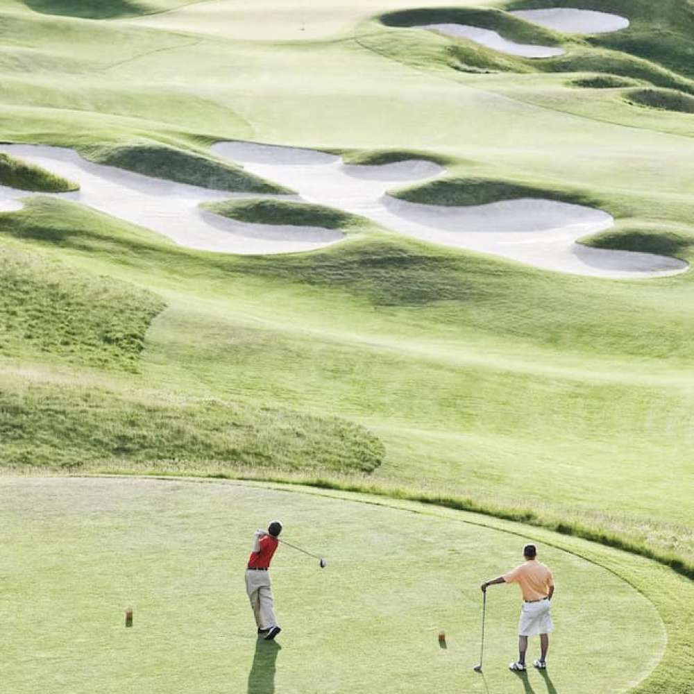 view-from-above-of-two-golfer-teeing-off-on-a-golf-2022-03-04-02-14-26-utc.jpg
